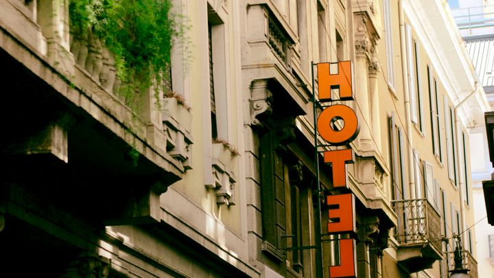 A hotel sign on a building on a city street